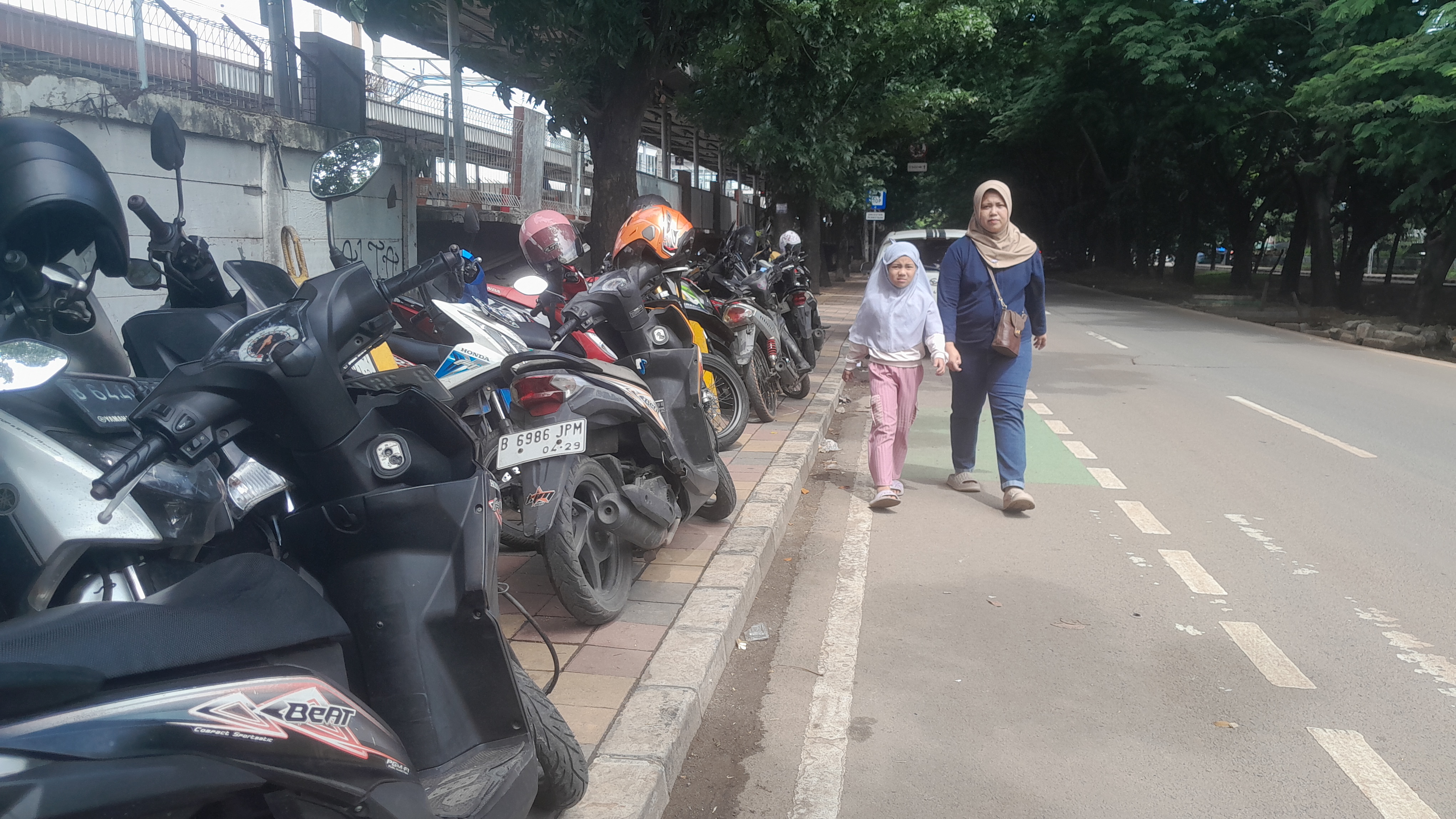 Sejumlah kendaraan roda dua nampak diparkir di atas trotoar di Jalan Benteng Betawi, Cipondoh. Sebelumnya kendaraan banyak parkir di RTH dekat Stasiun Batuceper.