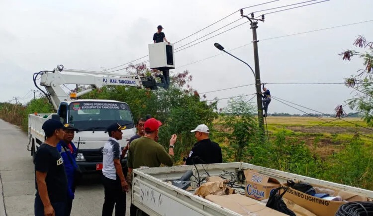 Petugas Dinas Perhubungan (Dishub) Kabupaten Tangerang terlihat sedang melakukan perbaikan PJU yang mengalami kerusakan.