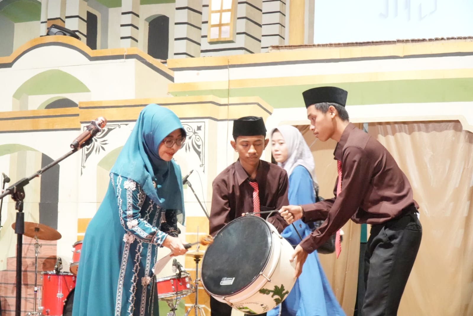 MEMBUKA ACARA. Bupati Pandeglang Raden Dewi Setiani, secara simbolis memukul drumband yang menandakan membuka acara Panggung Kreasi Santri dan Haflah Khataman di Ponpes Al-Madina, tepatnya di Kampung Kadubincarung, Desa Kadubale, Kecamatan Banjar, Kabupaten Pandeglang, Sabtu (4/7) malam.  (DOK. PROKOPIM SETDA PANDEGLANG)