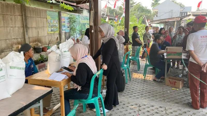 PEMBAGIAN BANSOS - Suasana pembagian bantuan beras. Jumlah penerima bantuan pangan berupa beras dari pemerintah di Kelurahan Sawah Baru, Kecamatan Ciputat